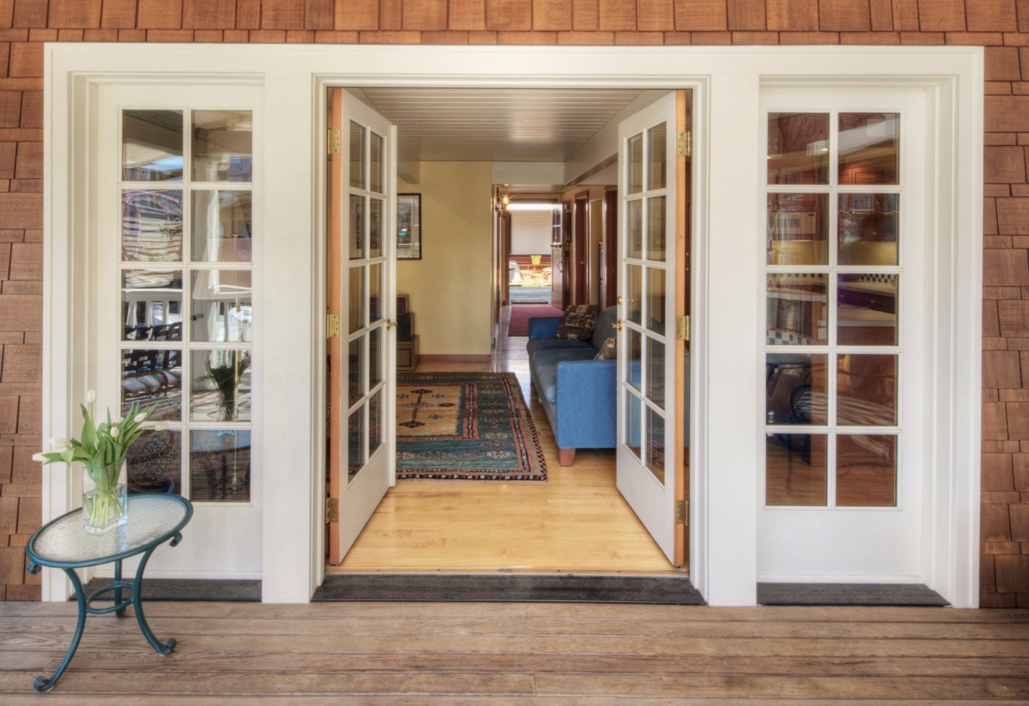 White double hinged glass doors opening into a home.