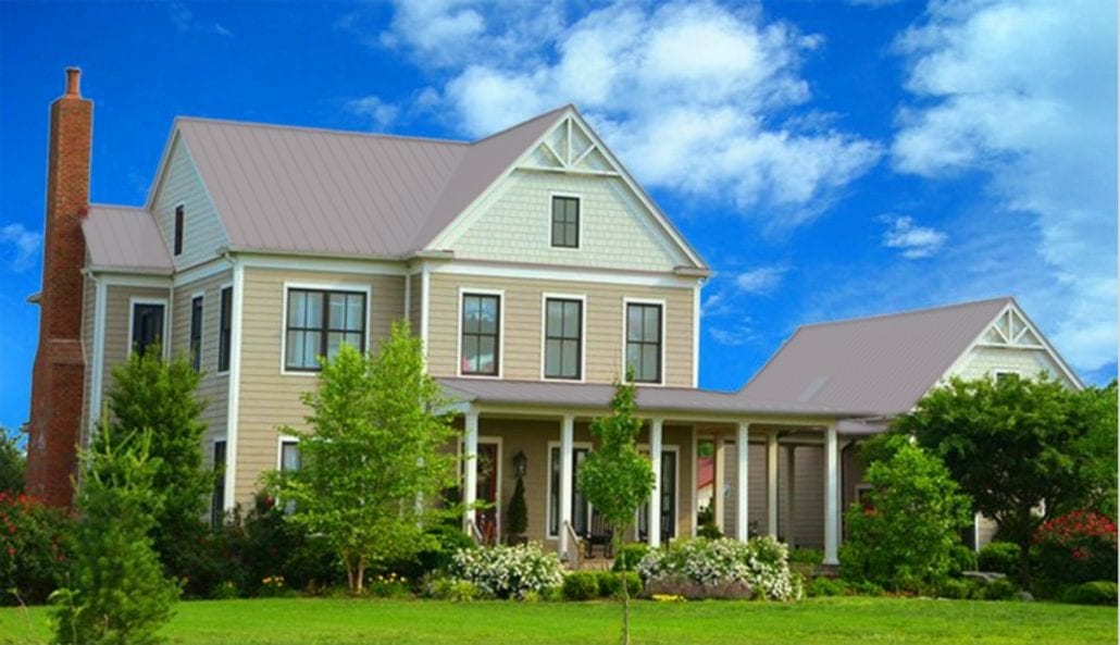 A large 3 story home with light gray metal residential roofing.