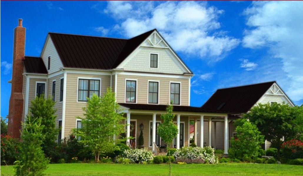 A large 3 story home with black metal residential roofing.