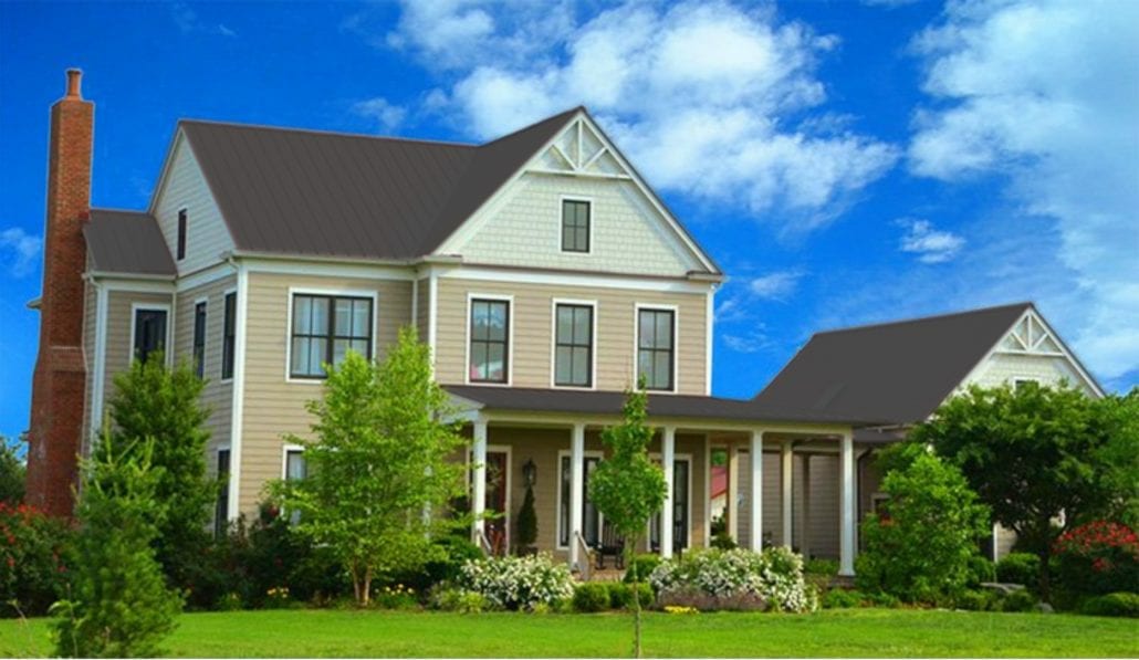 A large 3 story home with dark gray metal residential roofing.