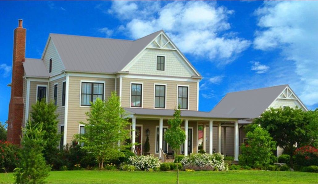 A large 3 story home with gray metal residential roofing.