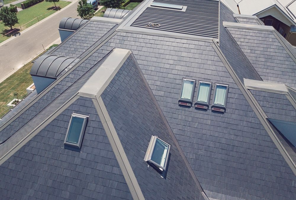 Five skylights on a home's slate specialty roof.