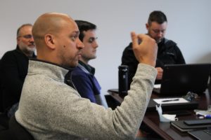 Four men having a meeting in an office in Dover, NH.