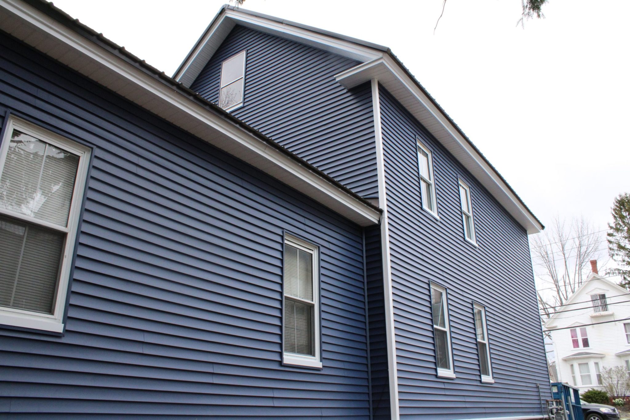 A home in Dover, NH with blue vinyl siding.