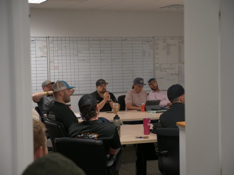 A group of men having a meeting in an office in Dover, NH.