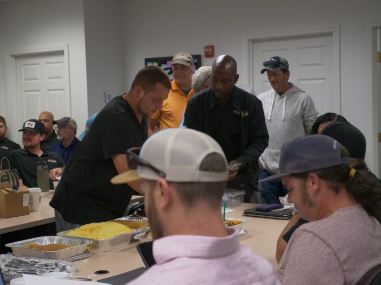 A group of men eating at a buffet in an office in Dover, NH