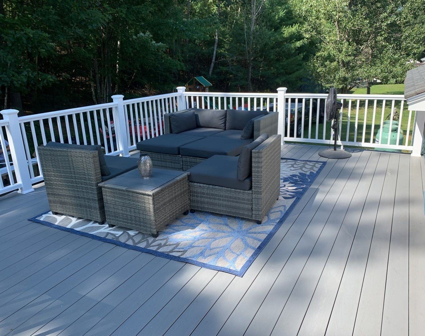 Southers Construction light grey composite decking project in Epping New Hampshire with patio furniture and a decorative rug