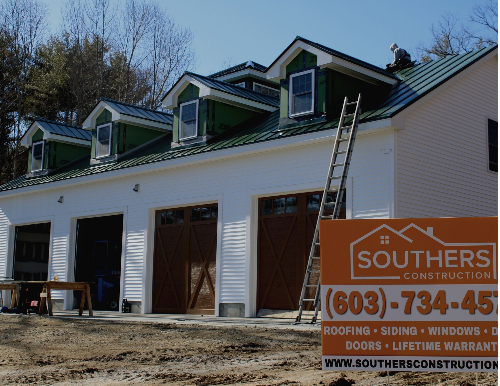 CertainTeed Siding and Green Metal Roof with a Southers Construction Sign