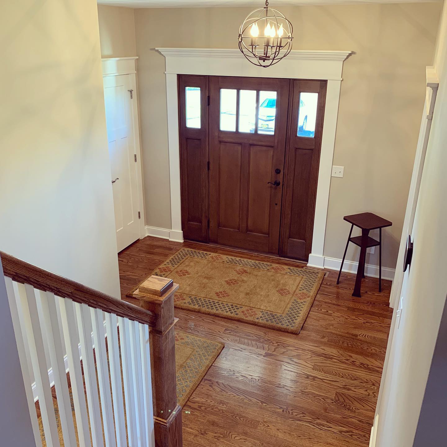 A wood entry door with three glass panels from the interior of the home.