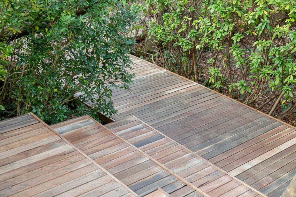 A wooden garden walkway made with pressure treated decking.