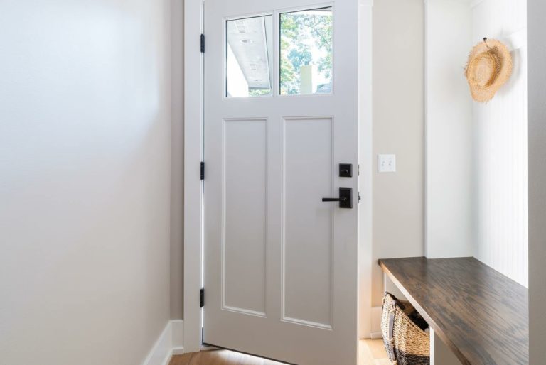 A white entry door left ajar on the interior as a home.