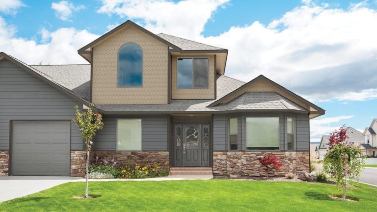 A home with Royal dark gray clapboard and tan half round shake siding.