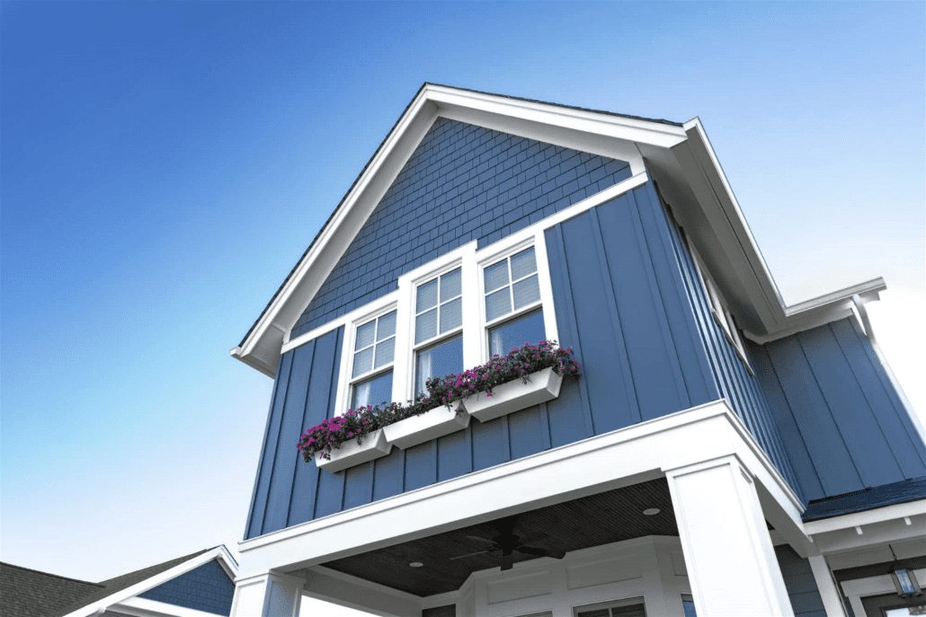 A home blue board & batten and shake siding with white trim and flower boxes under the windows.