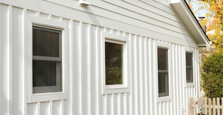 A close up of white JamesHardie HardiePanel board & batten siding.