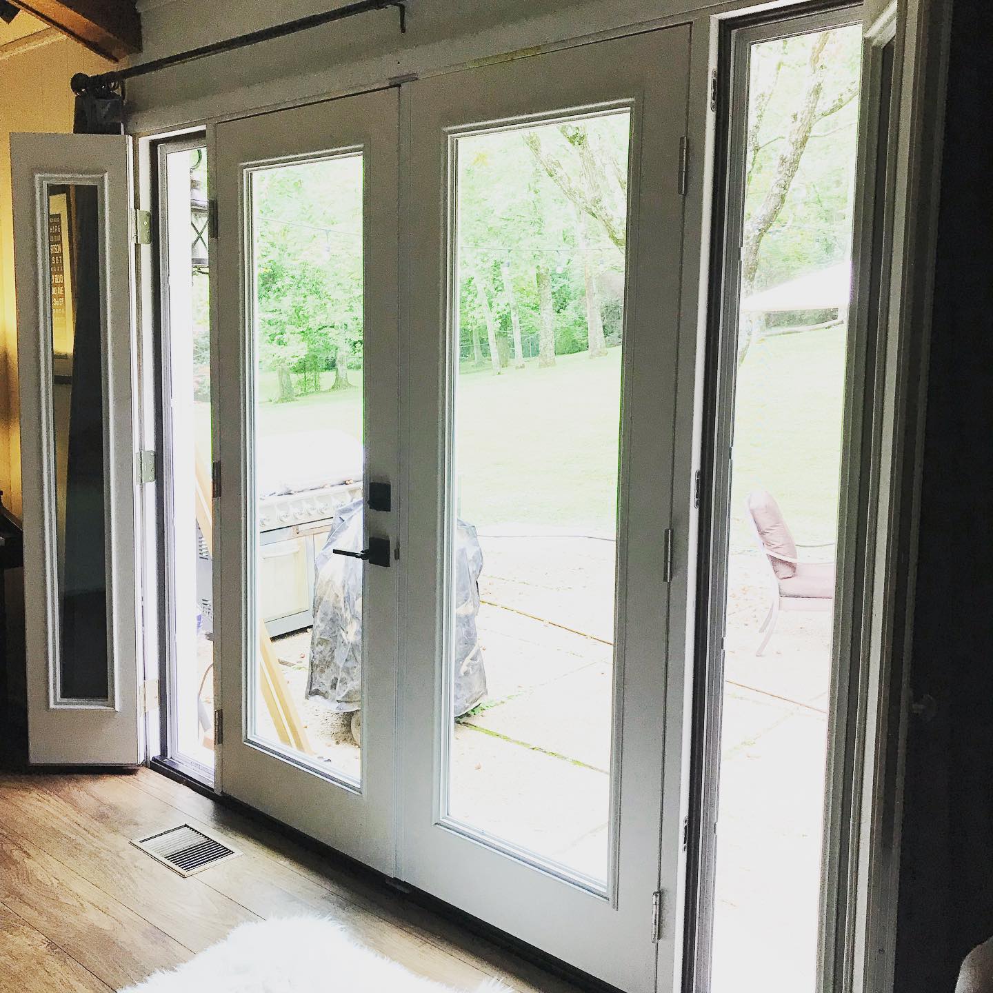 White double hinged patio doors with full length glass panes leading to a patio.
