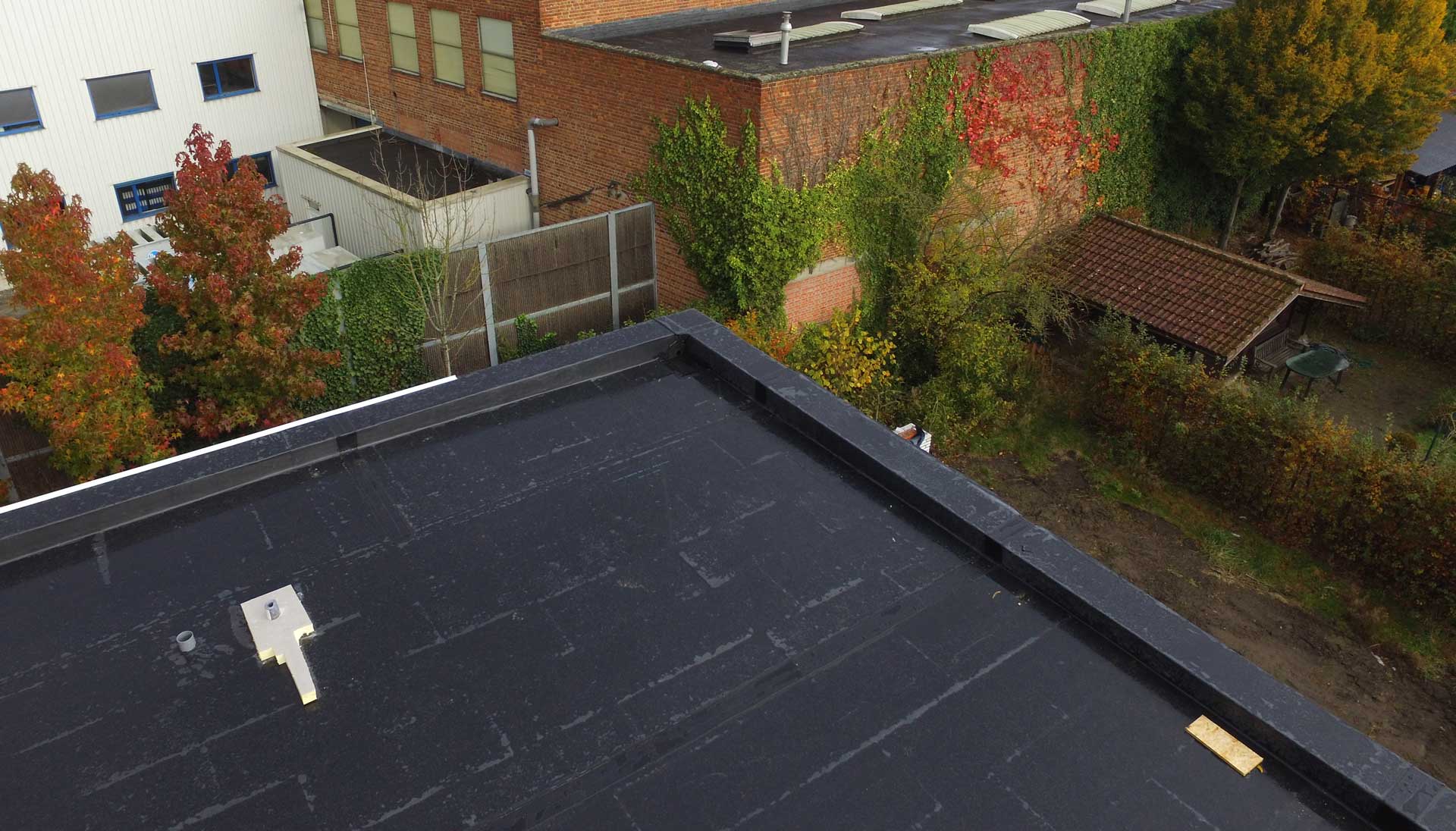 An overview of the top of a black, flat EPDM roof.