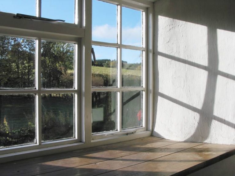 Aging wood windows on the interior of a home.