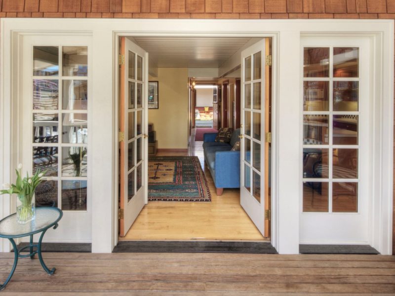 White double hinged glass doors opening into a home.