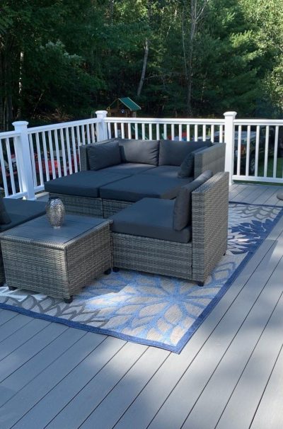 Southers Construction light grey composite decking project in Epping New Hampshire with patio furniture and a decorative rug