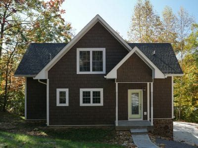 A home with brown TandoShake siding and white trim.