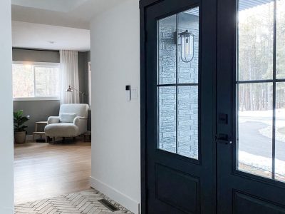 Black double hinged entry doors from the interior of the home.