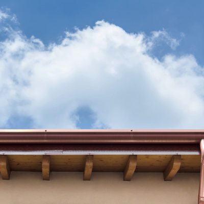 An underside view of a home’s copper seamless gutters.